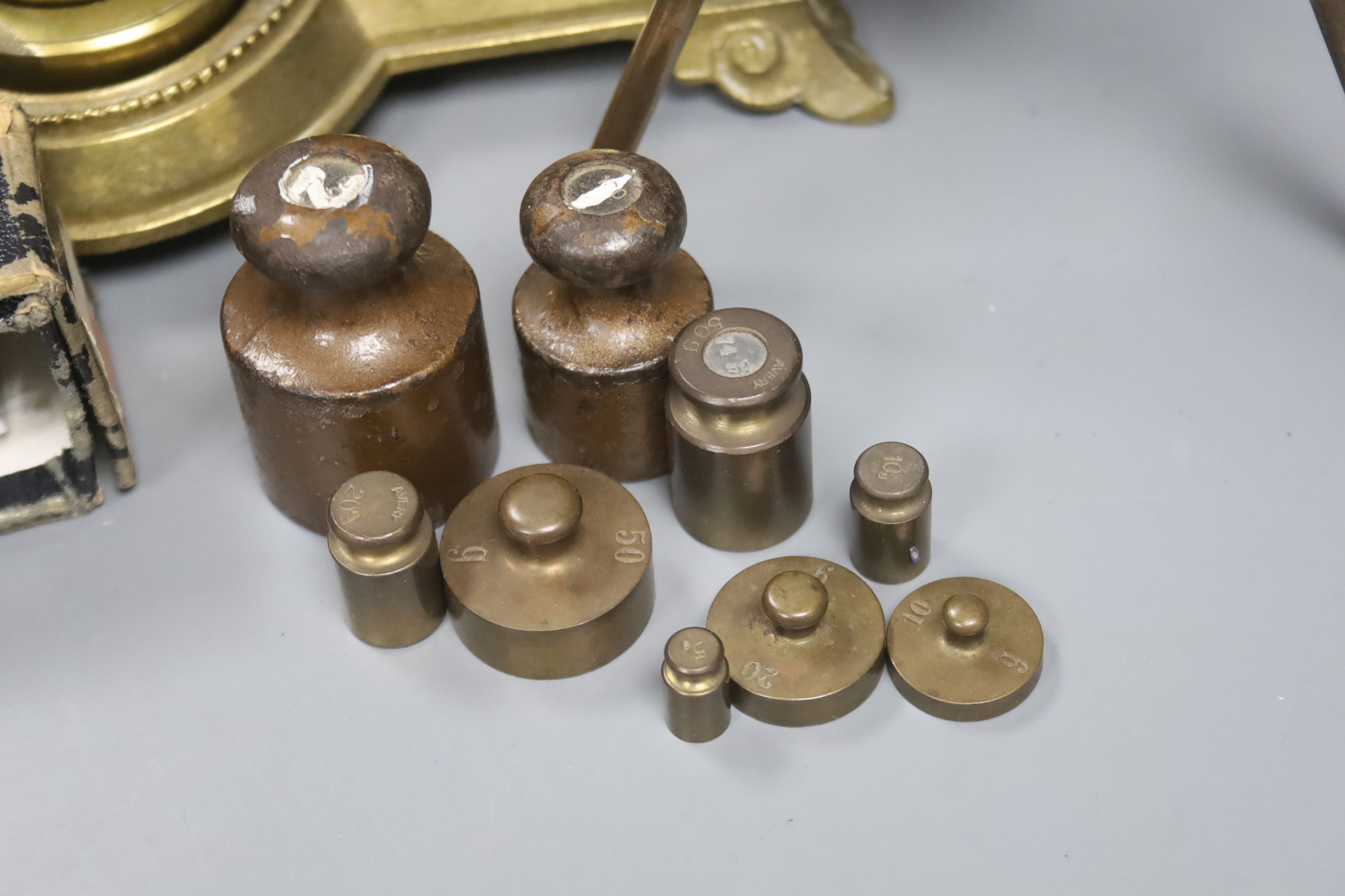 An Otis King's pocket calculator, a Voigtlander scope and brass postal scales